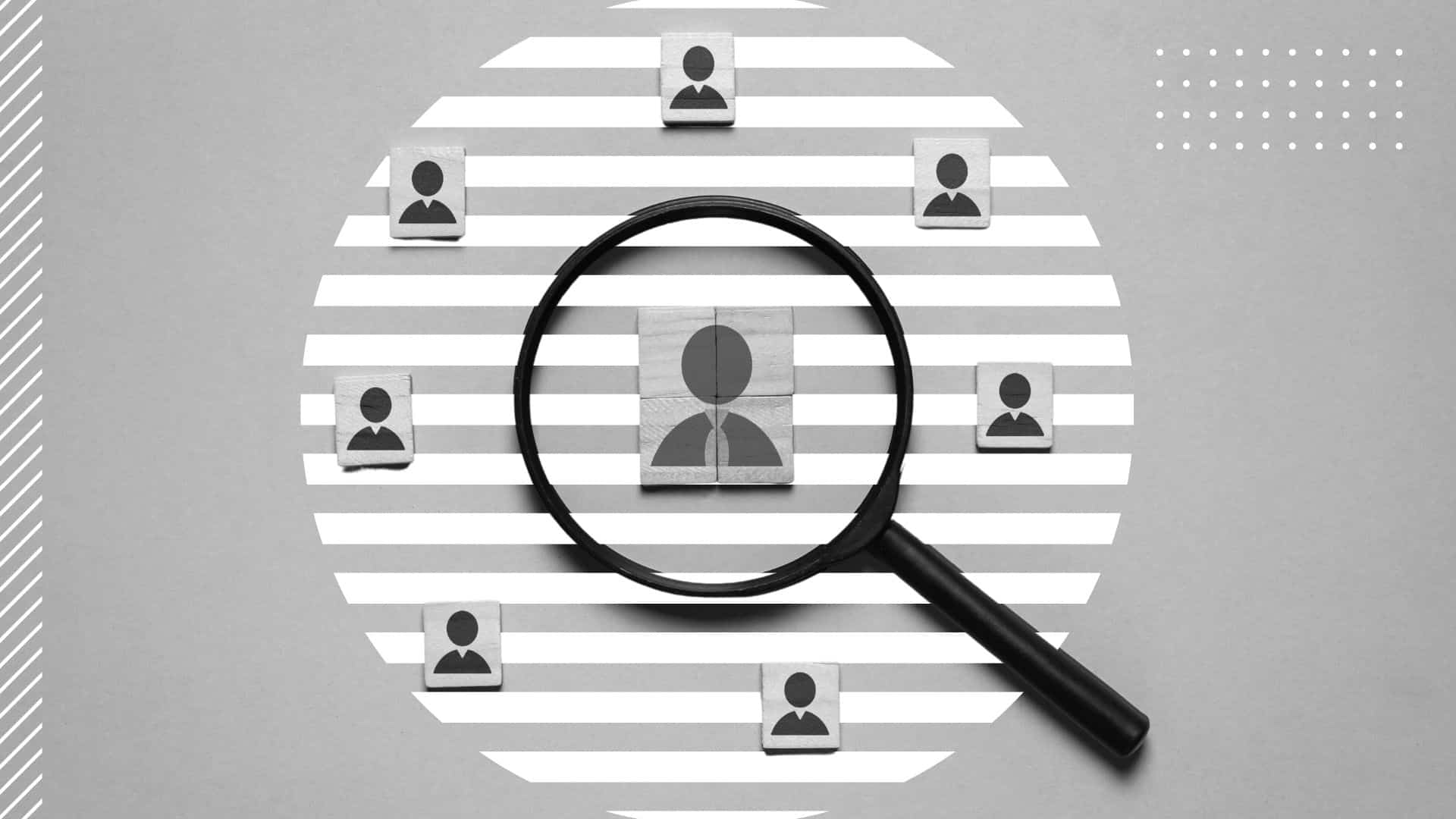black and white image of various blocks featuring a user icon, in the center is a larger block under a magnifying glass