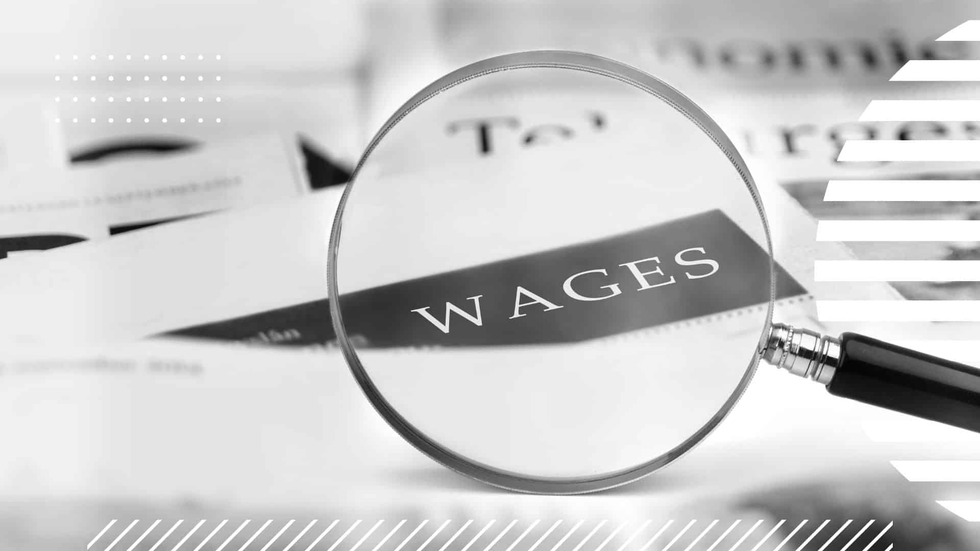 magnifying glass focusing on a corner of a paper that reads "WAGES"