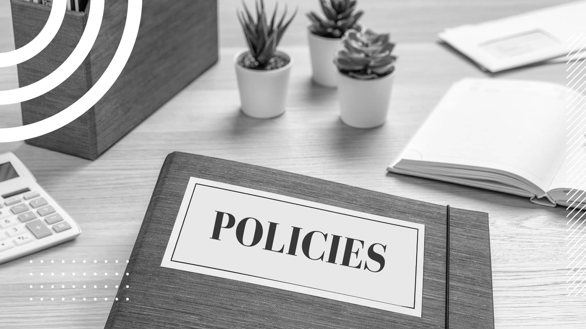 binder that reads "POLICIES" on a desk