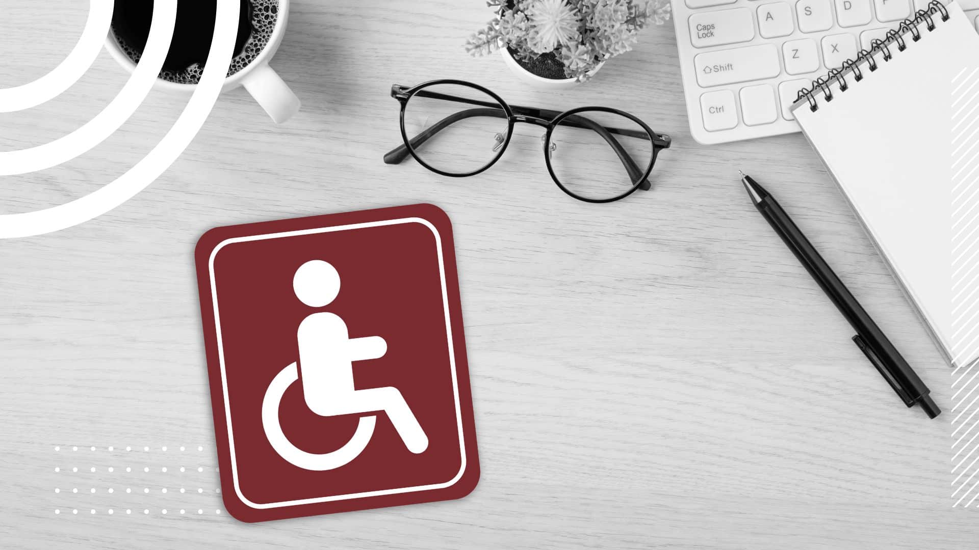 disability symbol block in red on a black and white desk