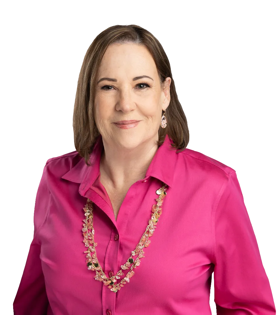 Helen Ross Petty — woman with shoulder length hair, wearing a bright magenta blouse and gold chain
