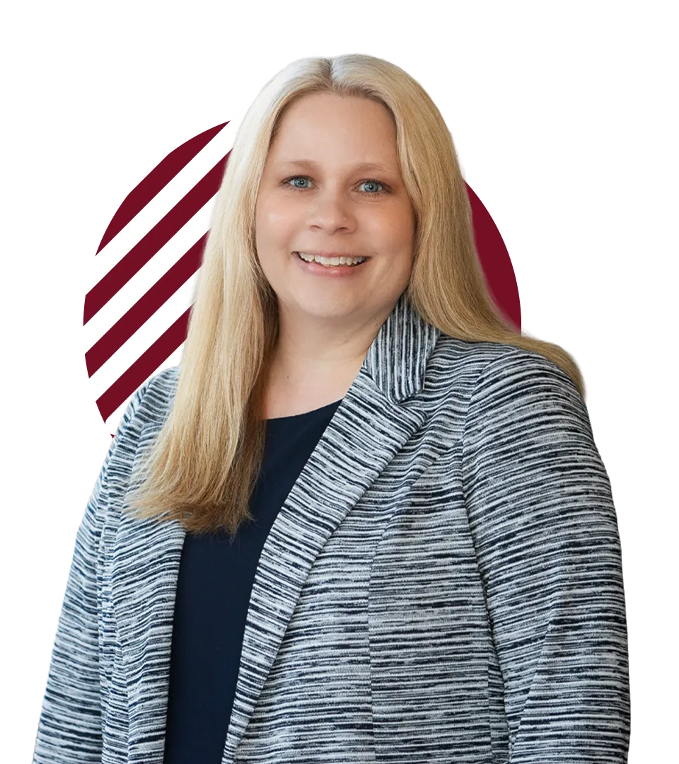 woman with long, straight blond hair wearing a gray heather cardigan over a black undershirt